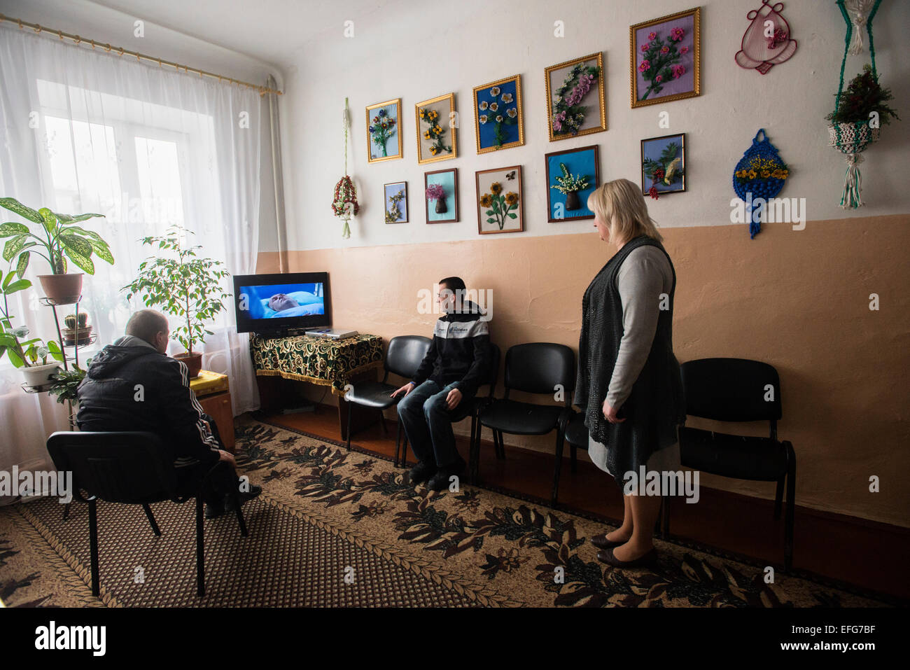 Zhytomyr, Ukraine. 2 of February, 2015. Teterivka's Orphanage and Boarding school has 85 pupils with mental and intellectual disorders, that can't manage without medical and specialists care. Governmental founding is sole way of founding for orphanage. Boys with intellectual disability watching TV in playing room, Teterivka's Orphanage and Boarding school. Zhytomyr, Ukraine. 2 of February, 2015. Credit:  Oleksandr Rupeta/Alamy Live News Stock Photo