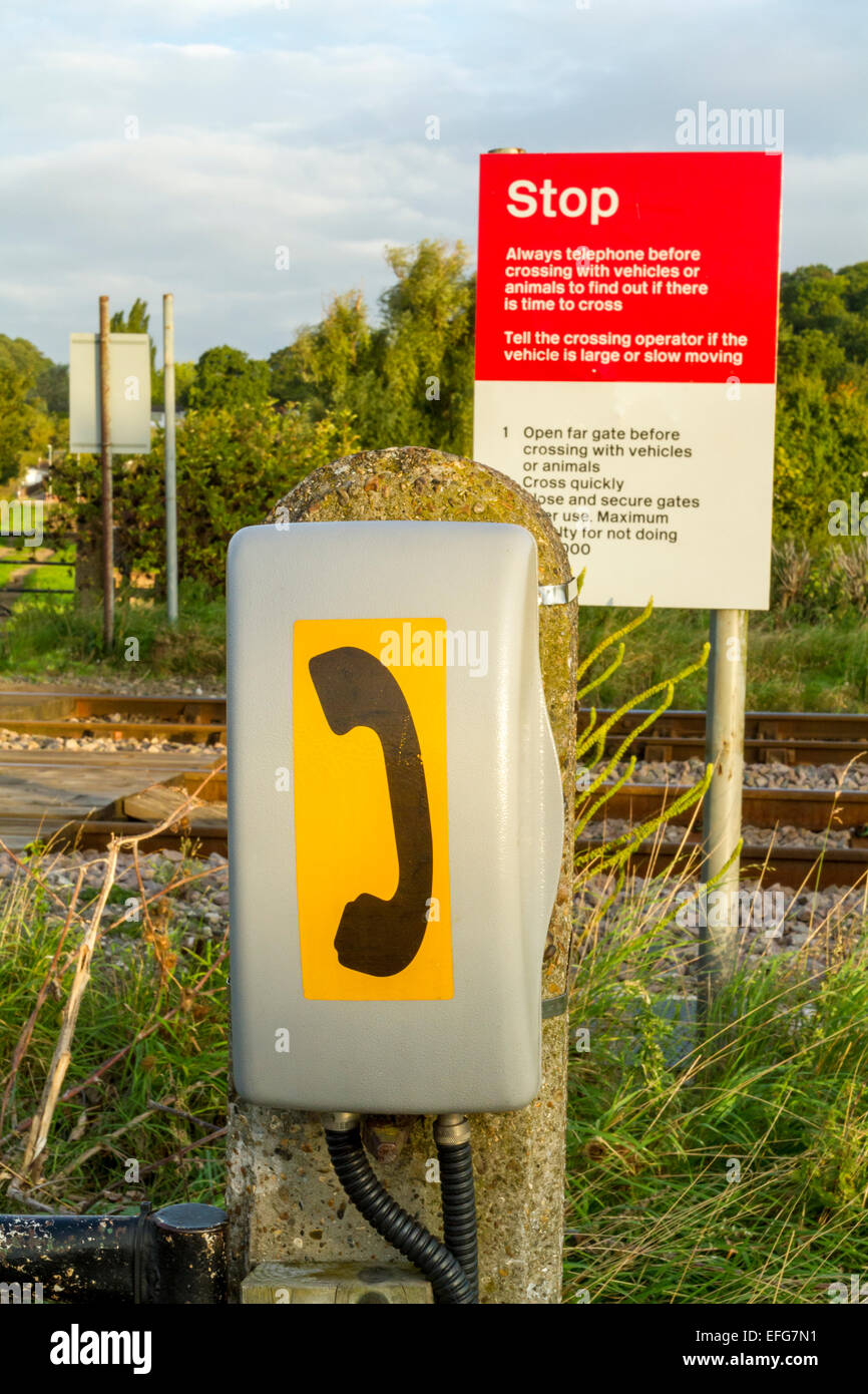 Phone and Stop sign at an unmanned and unprotected level crossing on a railway line in the countryside, Nottinghamshire, England, UK Stock Photo