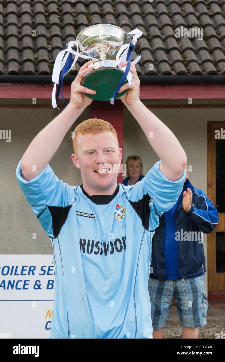 Newtonmore captain Owen Fraser lifts the Cup.  Newtonmore v Skye in the Strathdearn Cup Final, played at Spean Bridge. Stock Photo