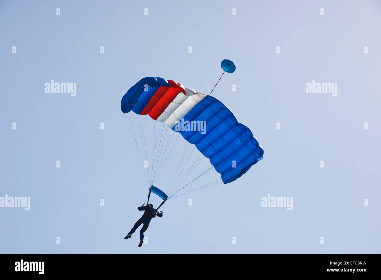 Parachutist jumping on a background of blue sky Stock Photo