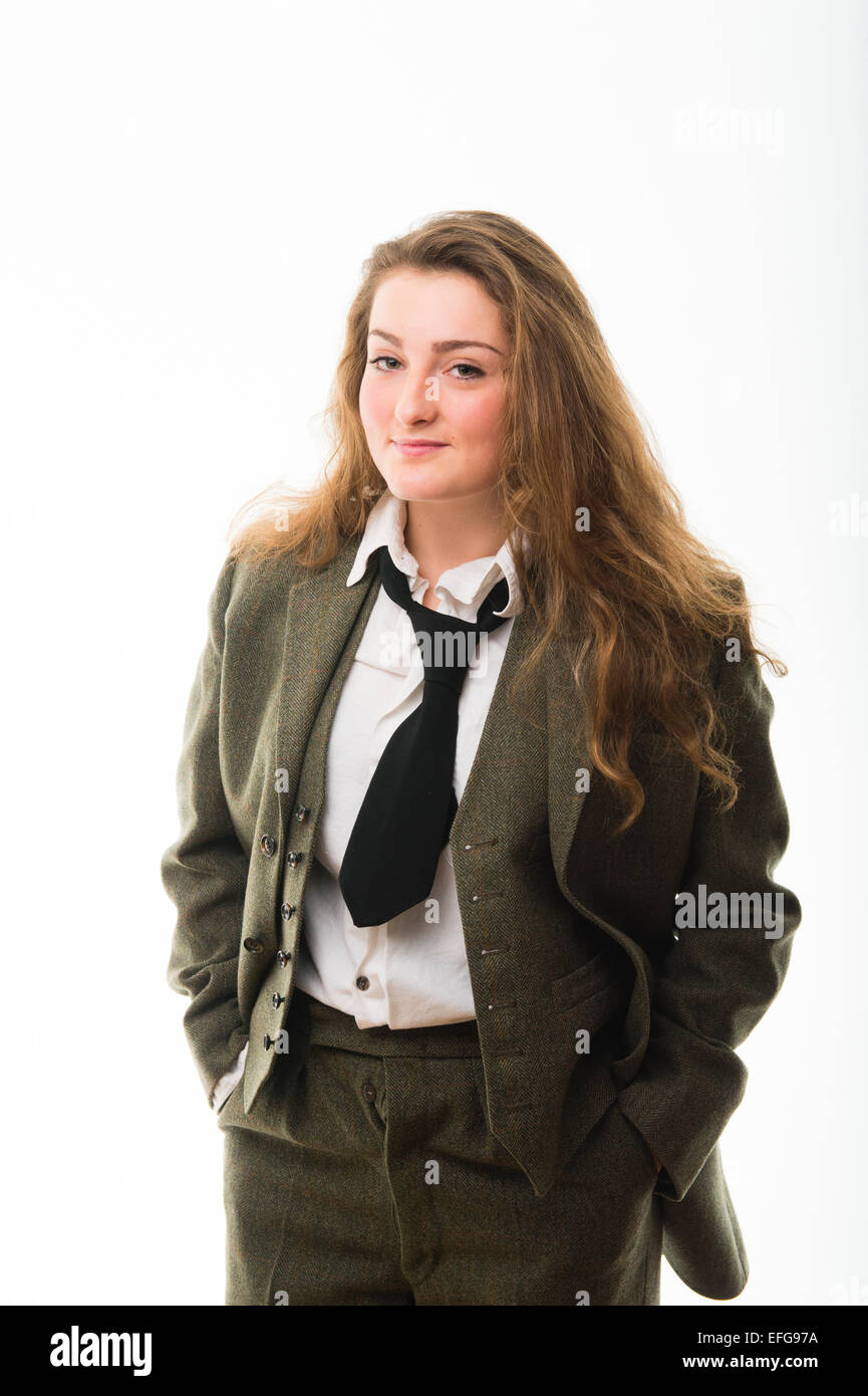Cross-dressing / Masculinity : A pretty fourteen 14 year old teenage girl with long brown hair, wearing a man's masculine clothes - green three piece traditional tweed suit shirt and tie  UK Stock Photo