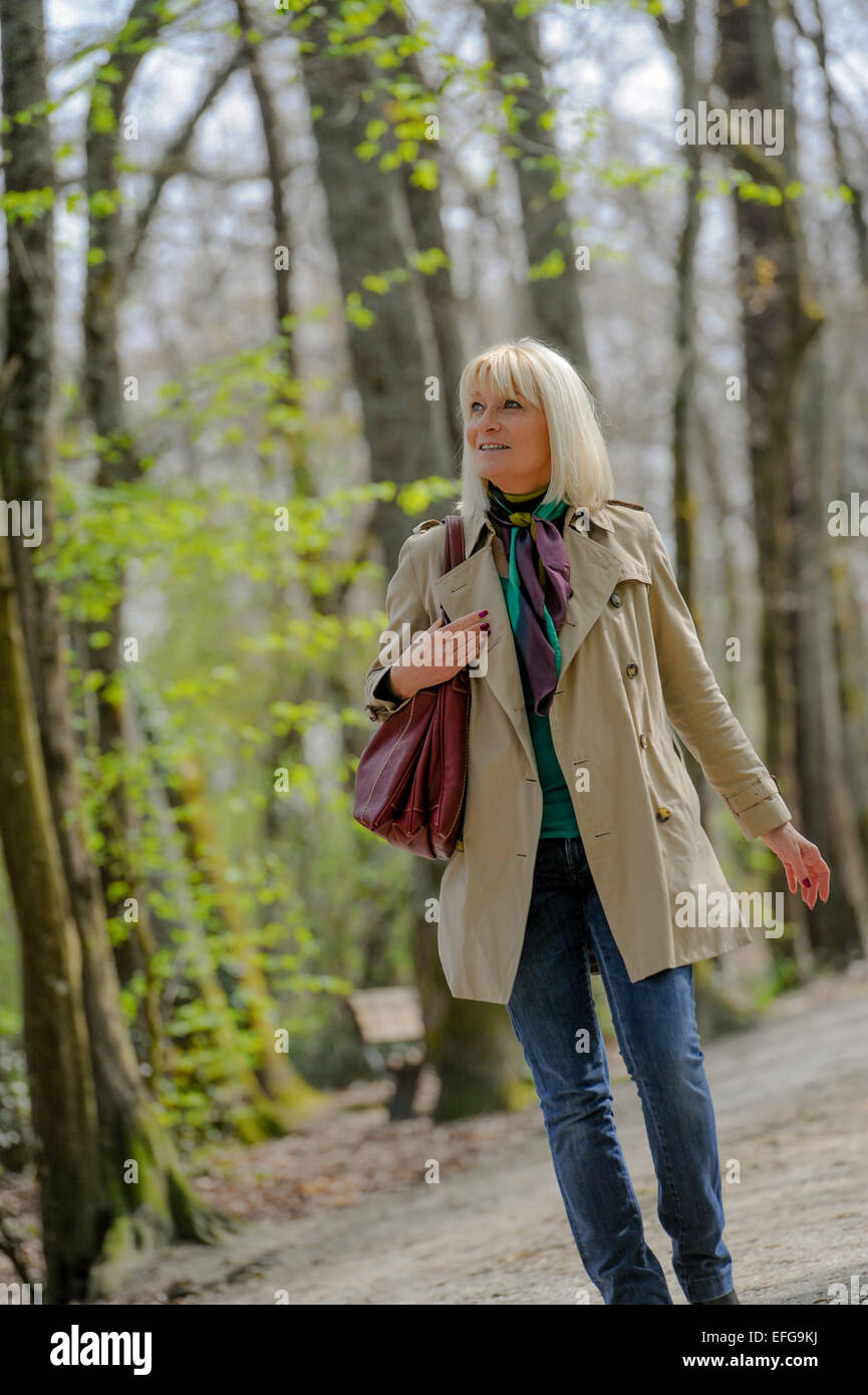 Senior woman walking in park hi-res stock photography and images - Alamy