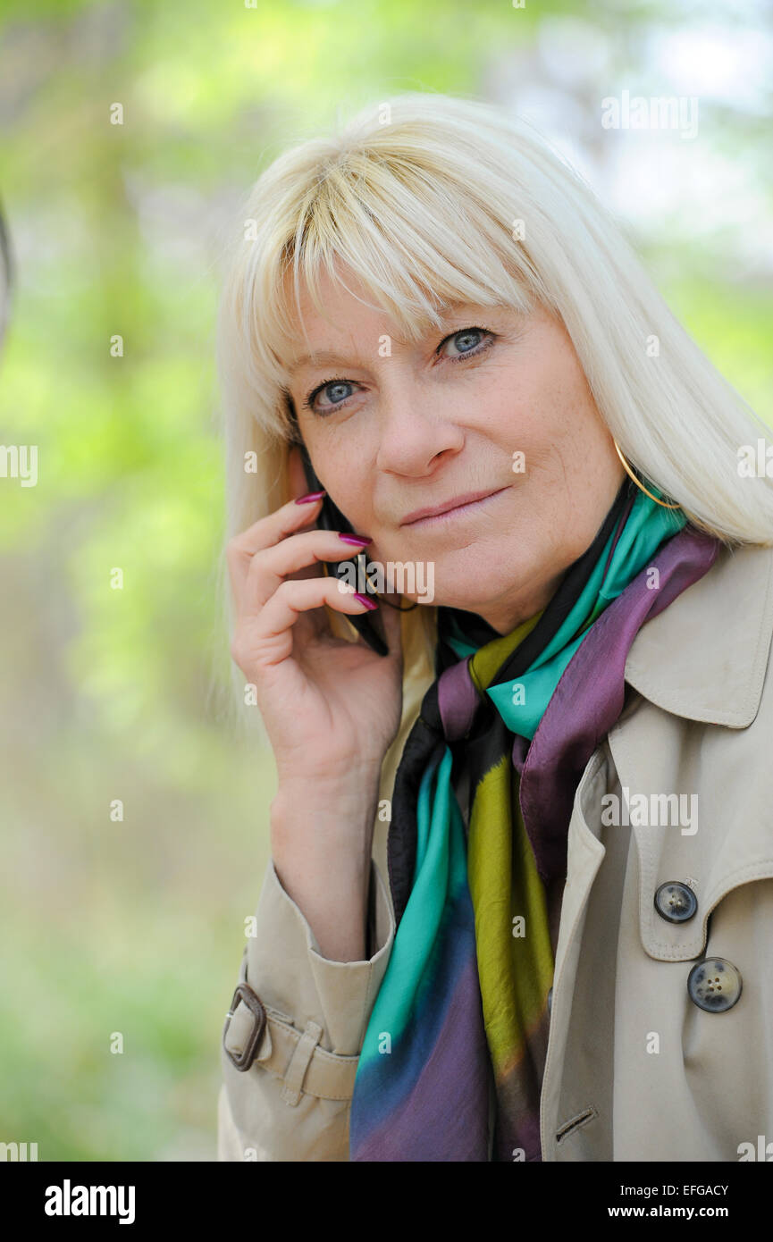 Senior woman happy phoning outdoor Stock Photo