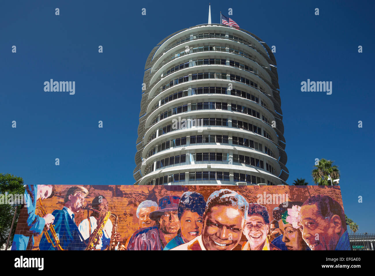 HOLLYWOOD JAZZ MURAL (©RICHARD WYATT JR 2012) CAPITOL RECORDS BUILDING TOWER  (©WELTON BECKETT 1956) VINE STREET HOLLYWOOD LOS ANGELES CALIFORNIA USA Stock Photo