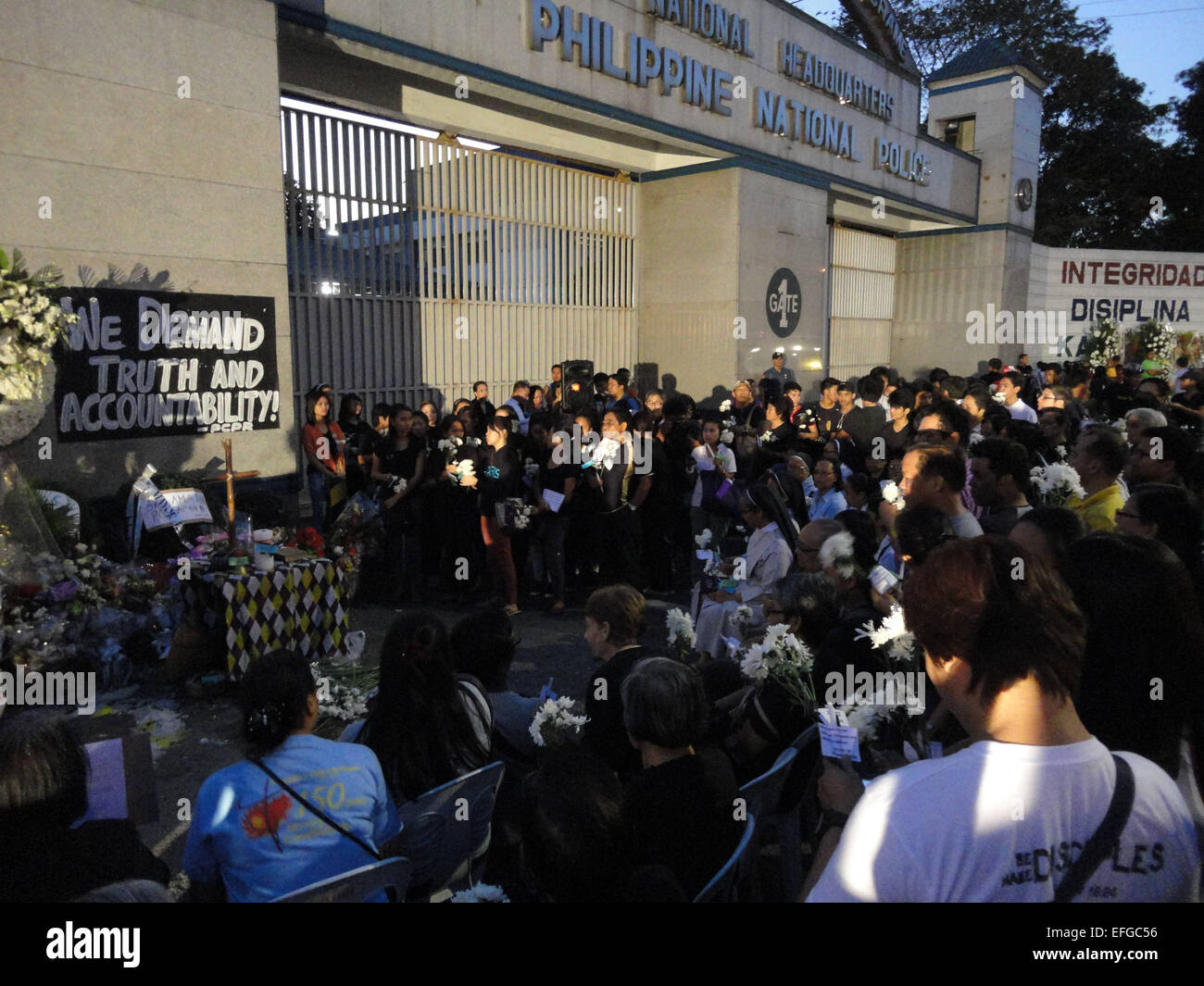 Quezon City, Philippines. 3rd Feb, 2015. Filipinos gather around an improvised altar outside the Philippine National Police headquarters, as they celebrate mass to commemorate the victims of the botched anti-terror operation in Mamasapano, Maguindanao. A mass was celebrated outside the Philippine National Police headquarters as they called for truth and accountability for the casualties of the botched anti-terror operation in Mamasapano, Maguindanao provionce last January 25, including 44 police commandos, as well as several civilians. Credit:  Richard James Mendoza/Pacific Press/Alamy Live Ne Stock Photo
