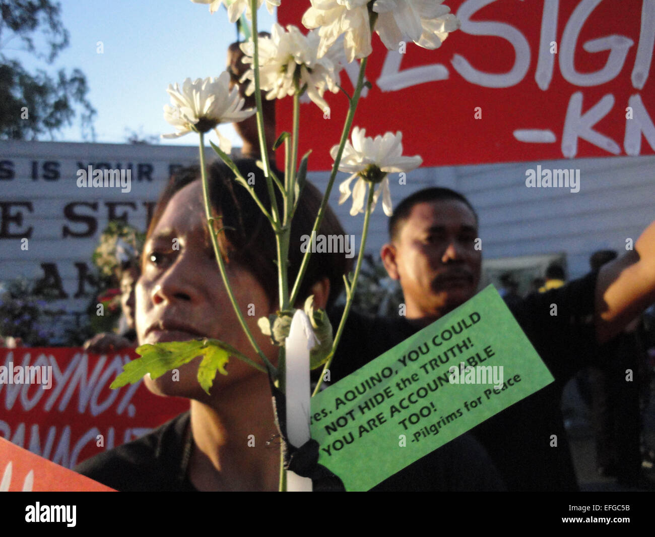 Quezon City, Philippines. 3rd Feb, 2015. Activists hold up placards, candles, and flowers outside the Philippine National Police headquarters. A mass was celebrated outside the Philippine National Police headquarters as they called for truth and accountability for the casualties of the botched anti-terror operation in Mamasapano, Maguindanao provionce last January 25, including 44 police commandos, as well as several civilians. Credit:  Richard James Mendoza/Pacific Press/Alamy Live News Stock Photo