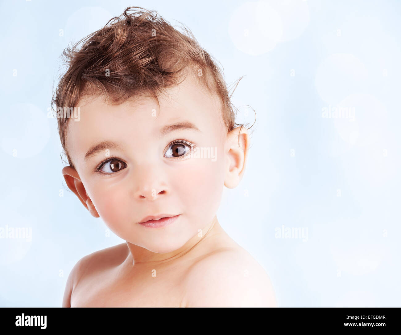 Cute baby boy over blue background, portrait with a copy space of an adorable sweet child, nice kid model indoor Stock Photo