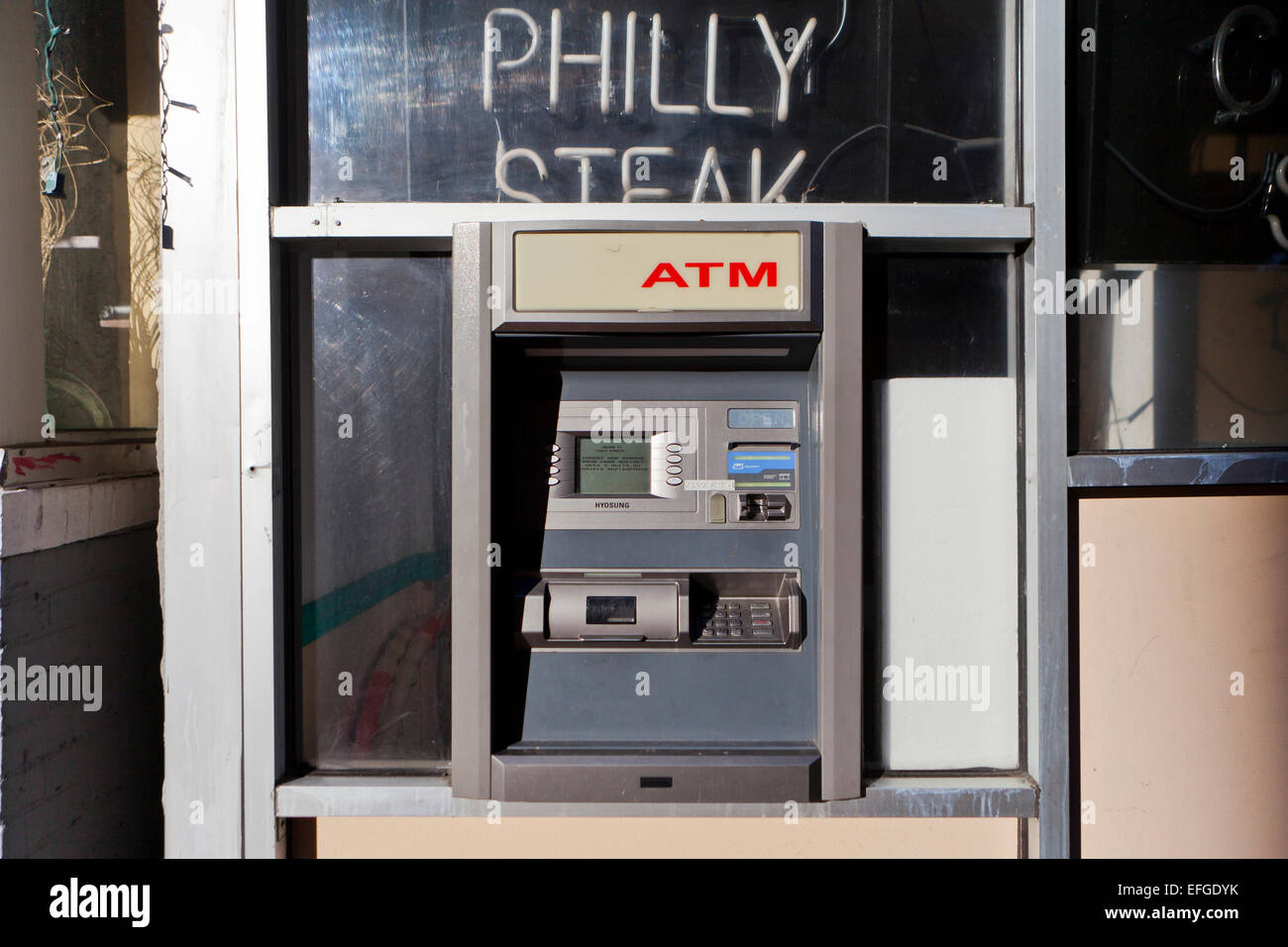 Old outdoor ATM machine on wall - USA Stock Photo