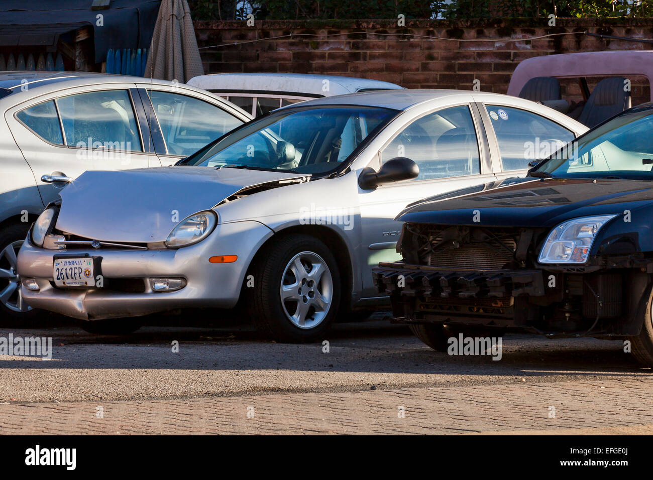 Car with front end collision damage at auto body repair shop - USA Stock Photo