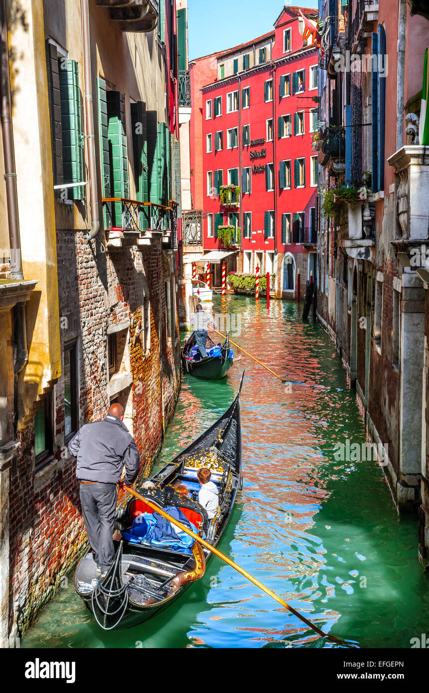 Venice, Italy. Image with tourists and gondola on small channel of Venice, Adriatic Sea in Italy. Stock Photo