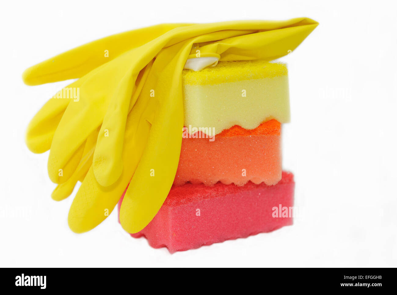 Rubber gloves and sponges for washing dishes isolated on white. Stock Photo