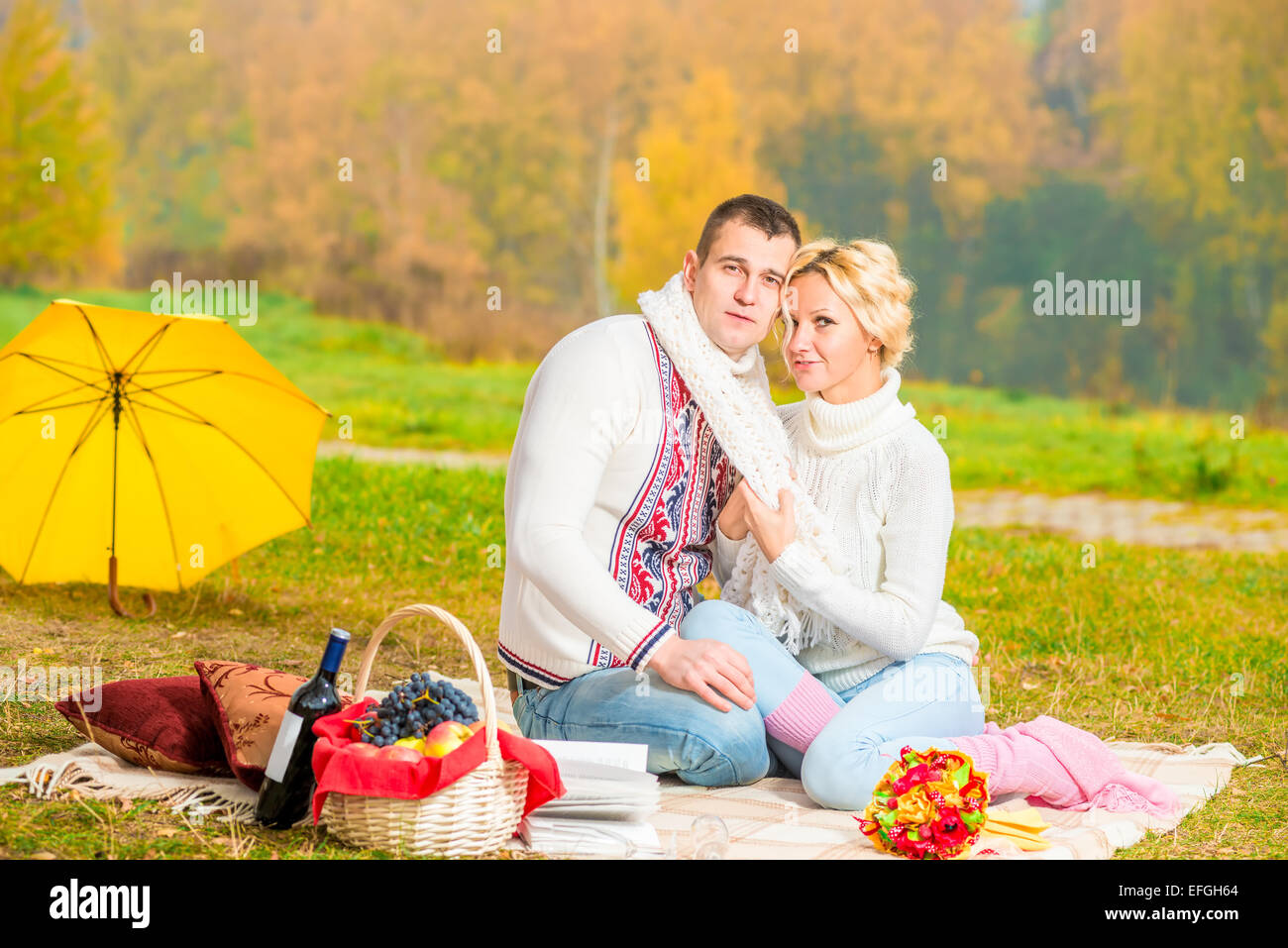 picnic young couple in a beautiful setting in the autumn park Stock Photo