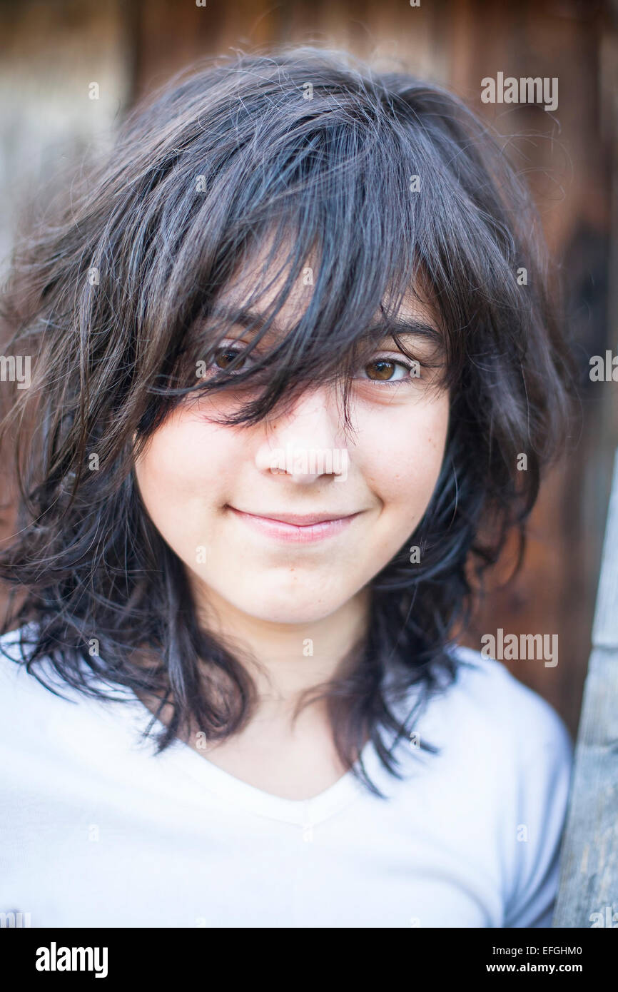 Portrait of teenage girl with tousled black hair. Stock Photo