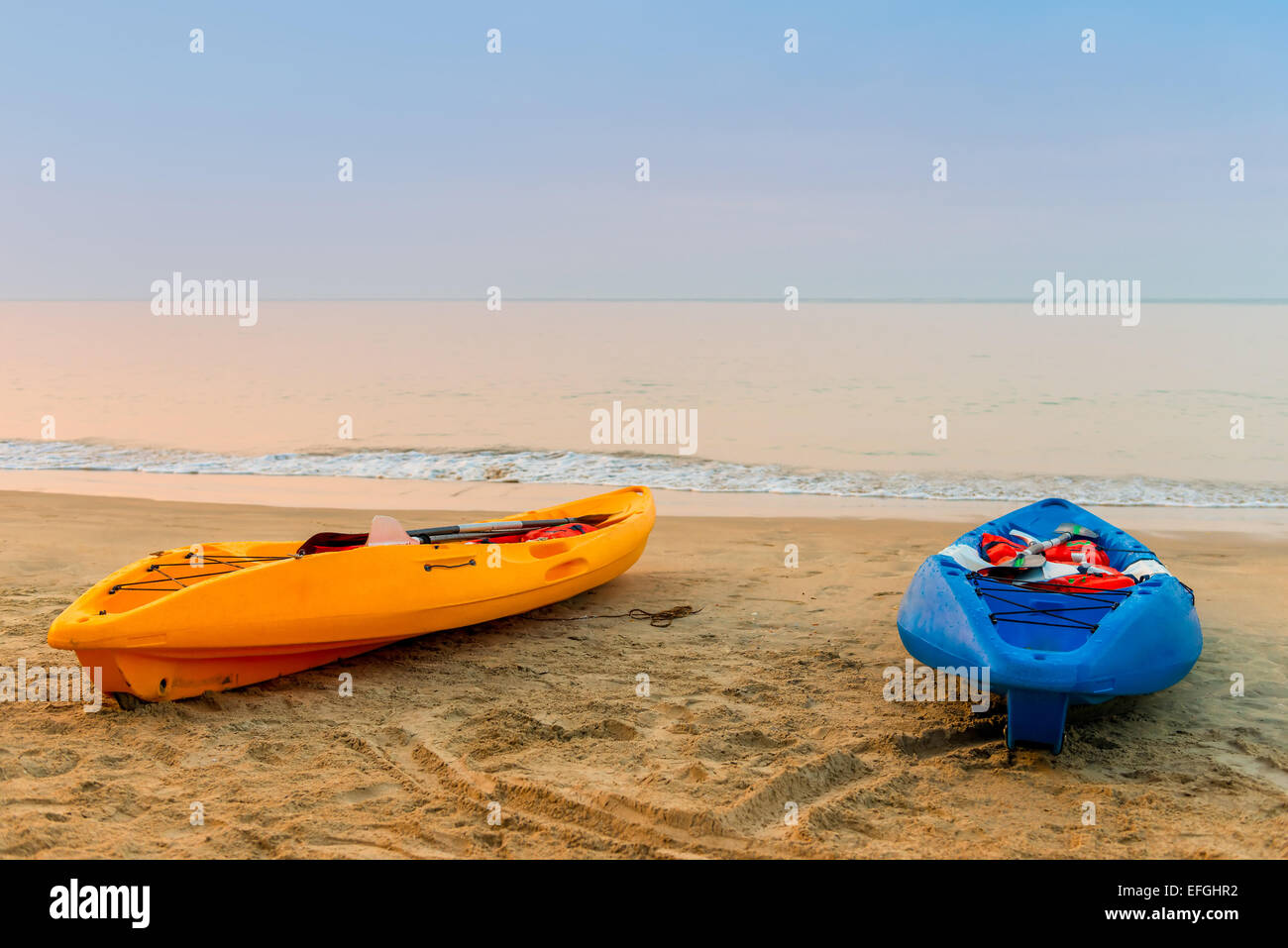 two kayaks on the beach early in the morning Stock Photo - Alamy