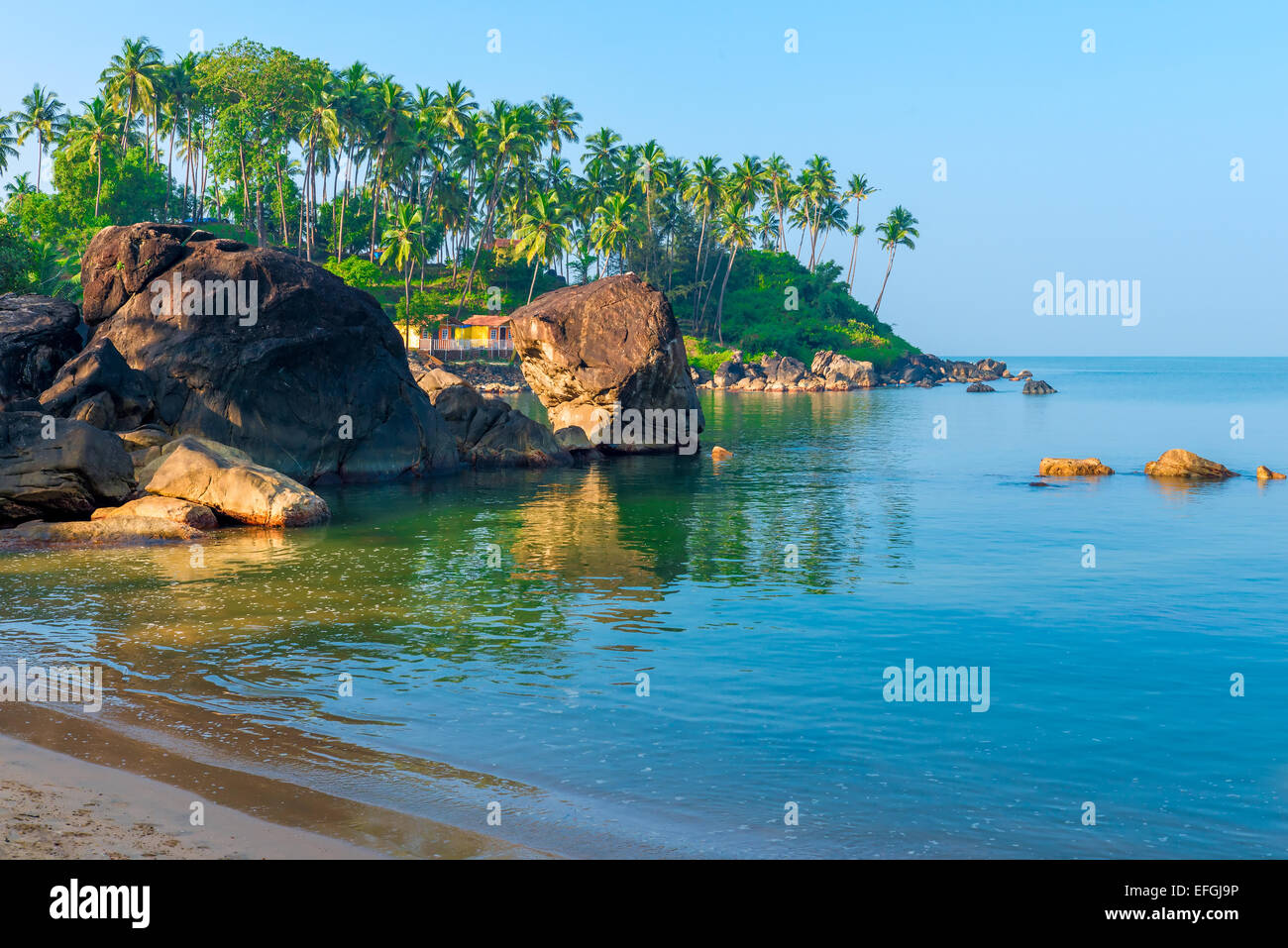 green palm trees and turquoise sea in a beautiful location Goa Stock Photo