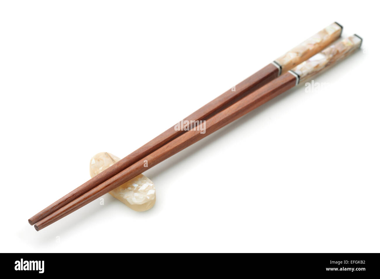 Wooden chopsticks on chopstick rest isolated on white Stock Photo