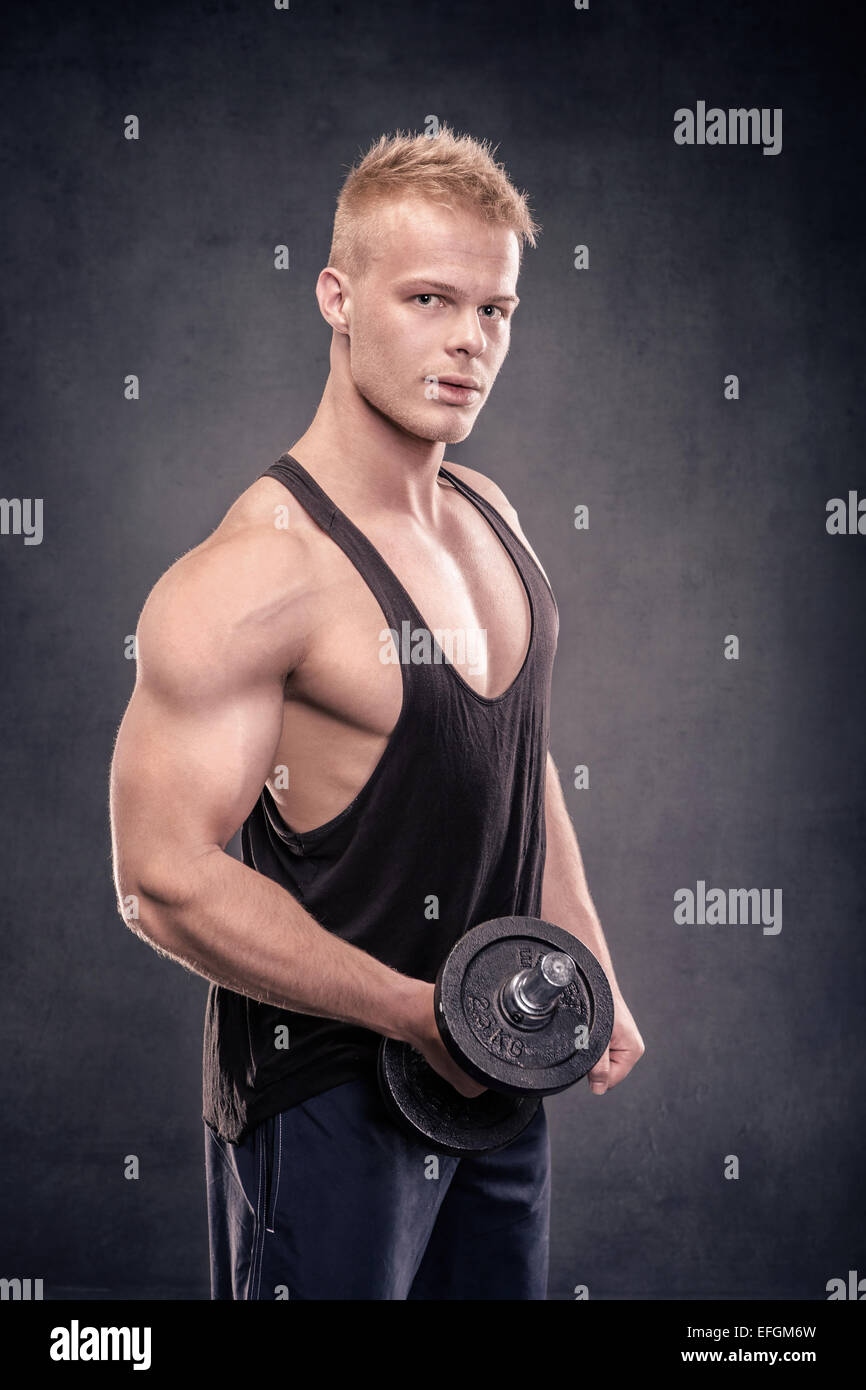 studio portrait of a young man in the bodybuilder pose Stock Photo