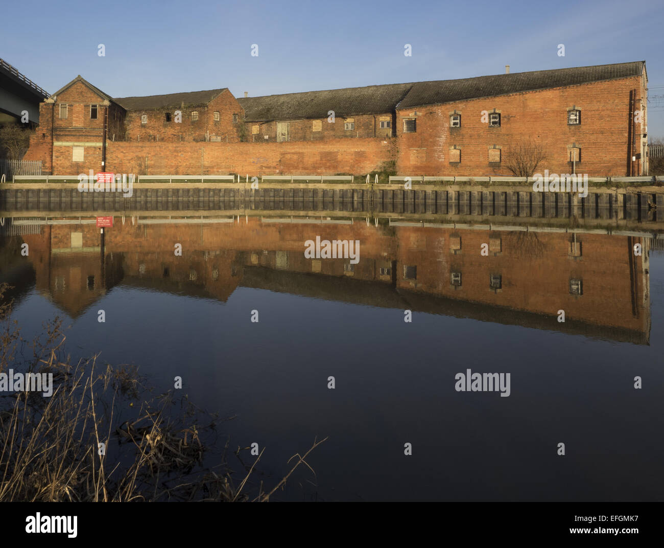 Old warehouse by the river Trent in Newark reflected in the river Stock Photo