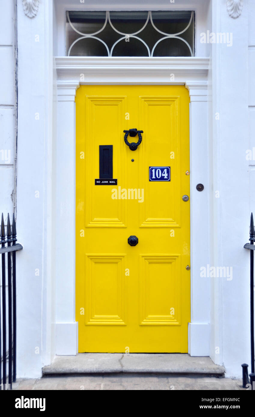 White Georgian house with a yellow door, Pimlico, London, UK. Stock Photo