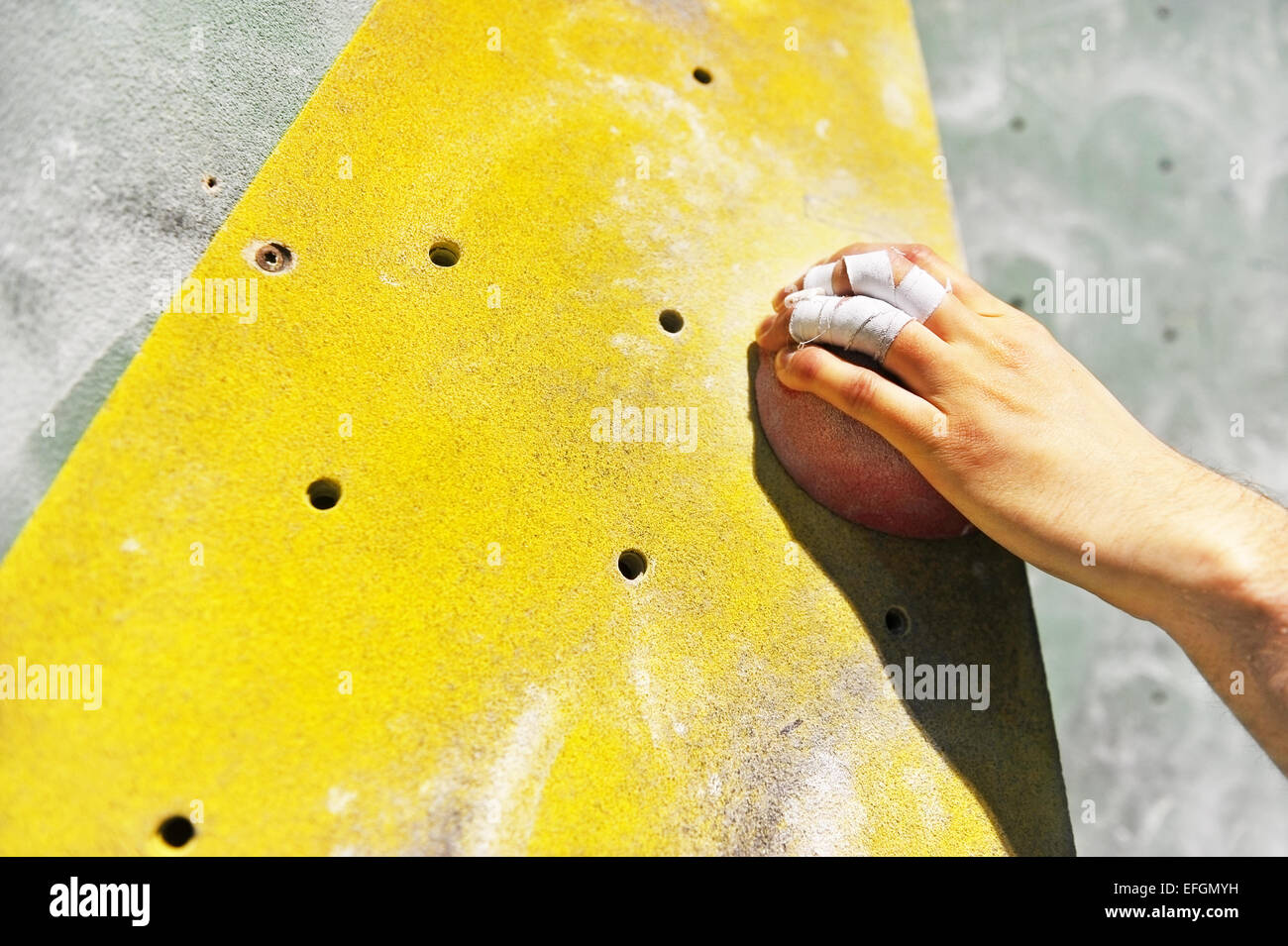 Detail with climber hand on artificial indoor climbing wall Stock Photo