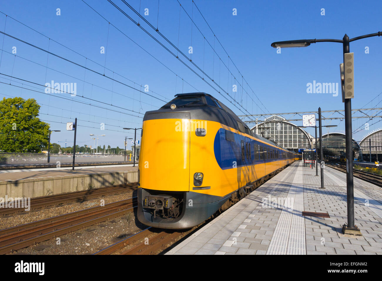 Train leaving Amsterdam Central Station. Stock Photo