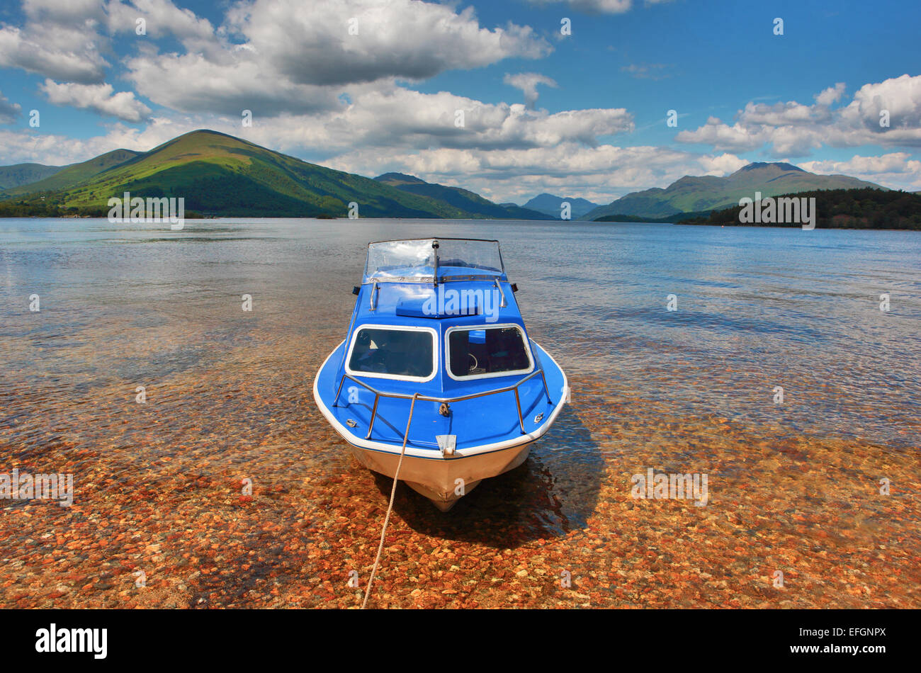 Small boat anchored to Inchconnachan island on Loch Lomond Stock Photo