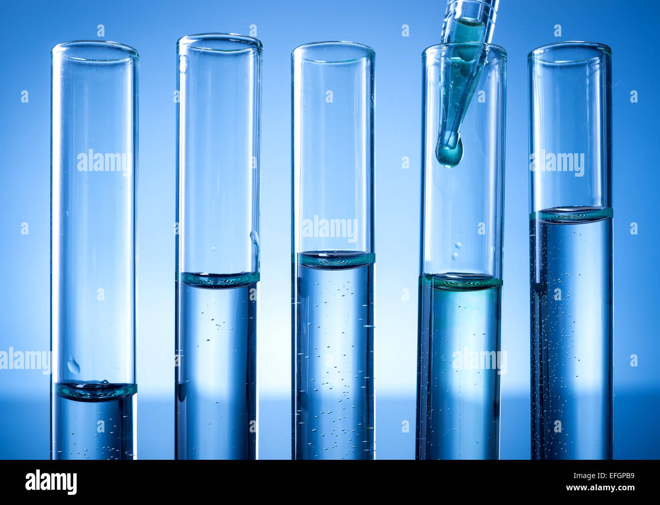Laboratory equipment, test tubes line, a drop of liquid Stock Photo - Alamy