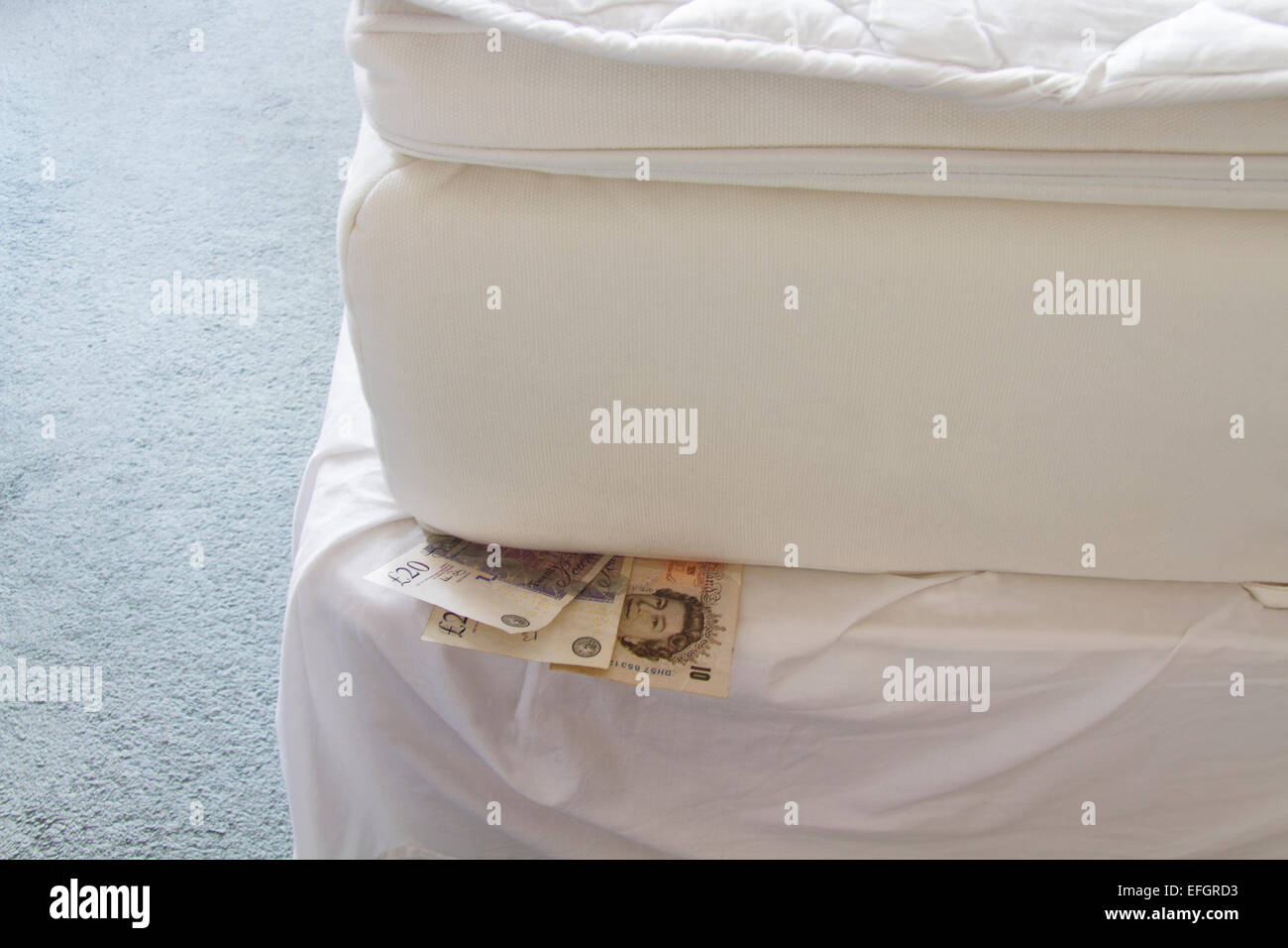 Cash under a mattress Stock Photo Alamy