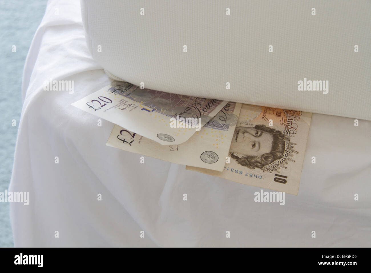 Cash under a mattress Stock Photo Alamy