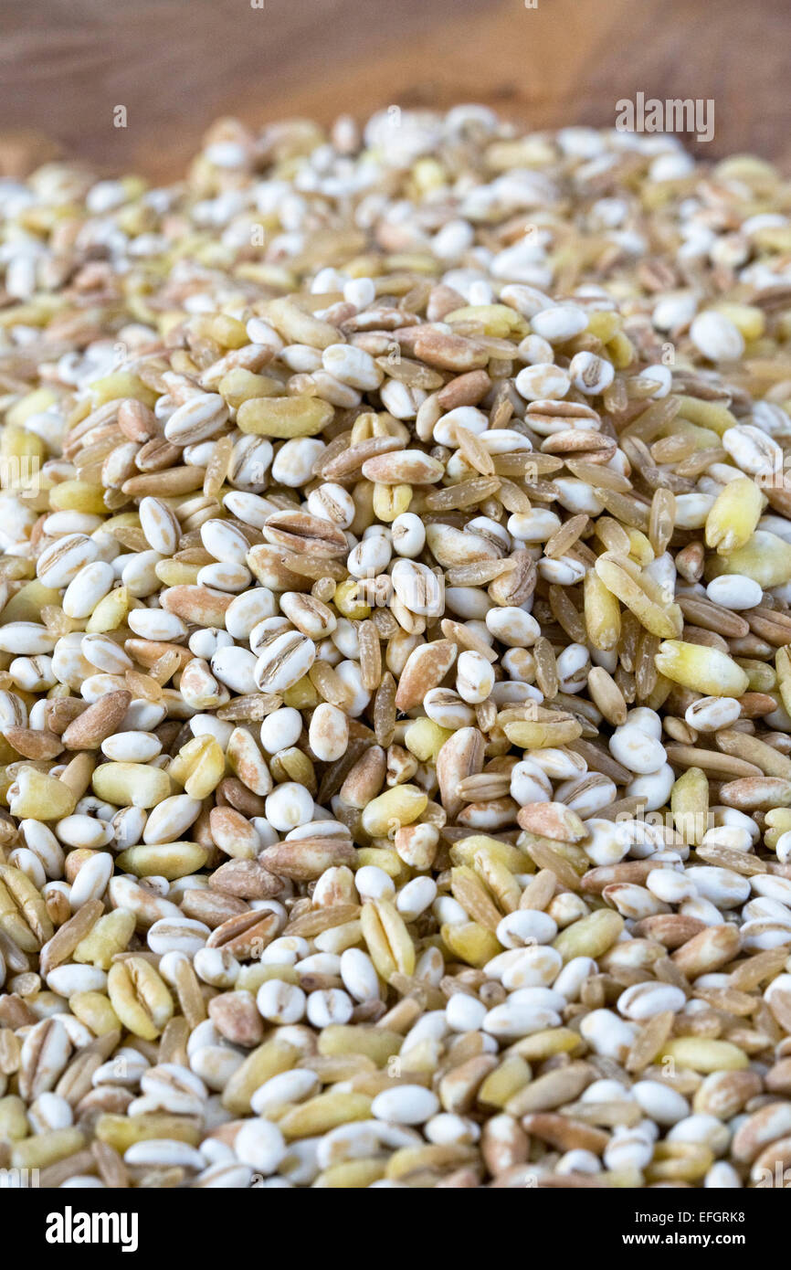 Mixed grains on a wooden board. Stock Photo