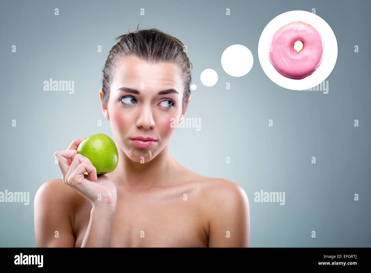 The Diet! Woman eating an apple , but he thinks a donut . Stock Photo