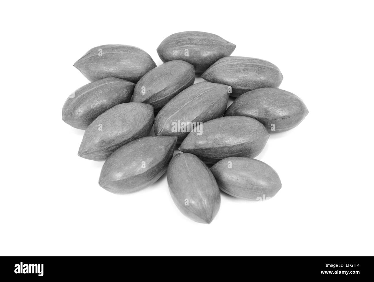 Pecan nuts in shells, isolated on a white background - monochrome processing Stock Photo