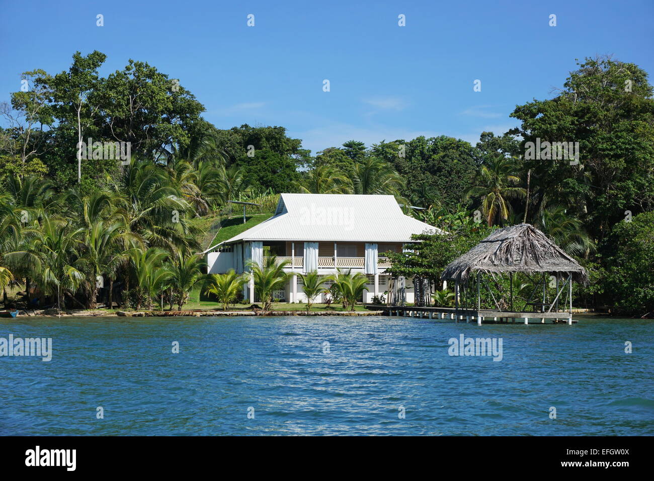Waterfront property with a Caribbean house and thatched hut over the sea, Bocas del Toro, Panama