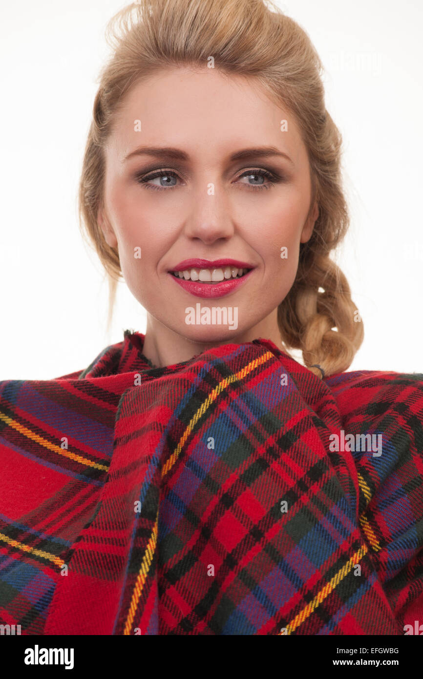 blonde woman wearing a red tartan shawl wrapped around her Stock Photo Alamy