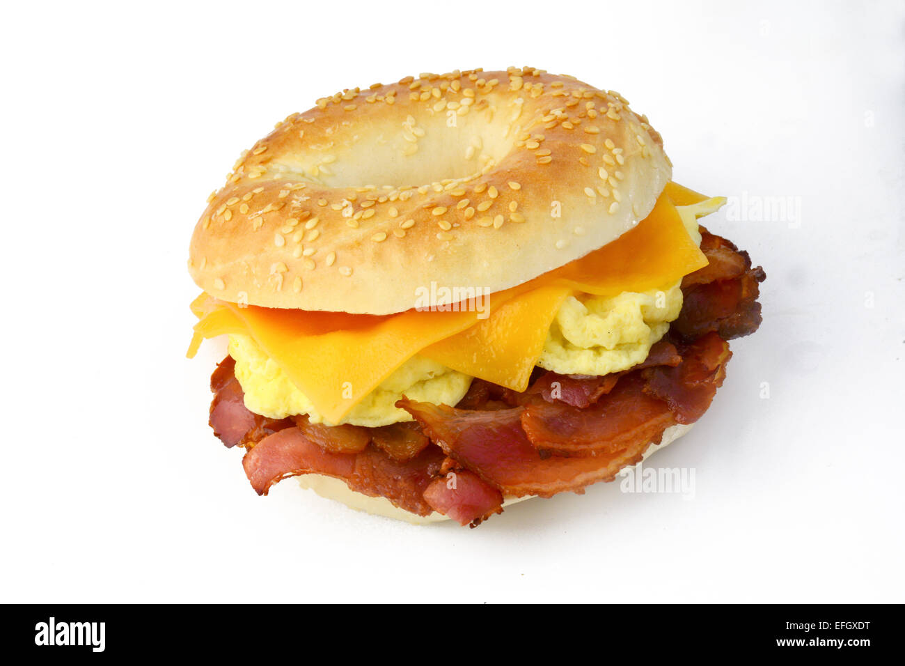 Bagel with fried bacon, scrumbled eggs and cheddar cheese. Studio isolated Stock Photo