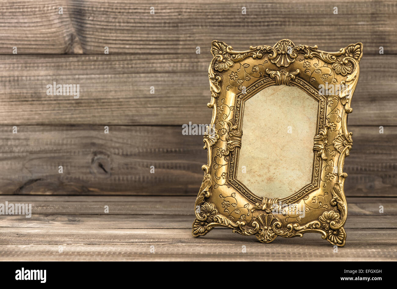 Golden baroque style picture frame on wooden background Stock Photo Alamy