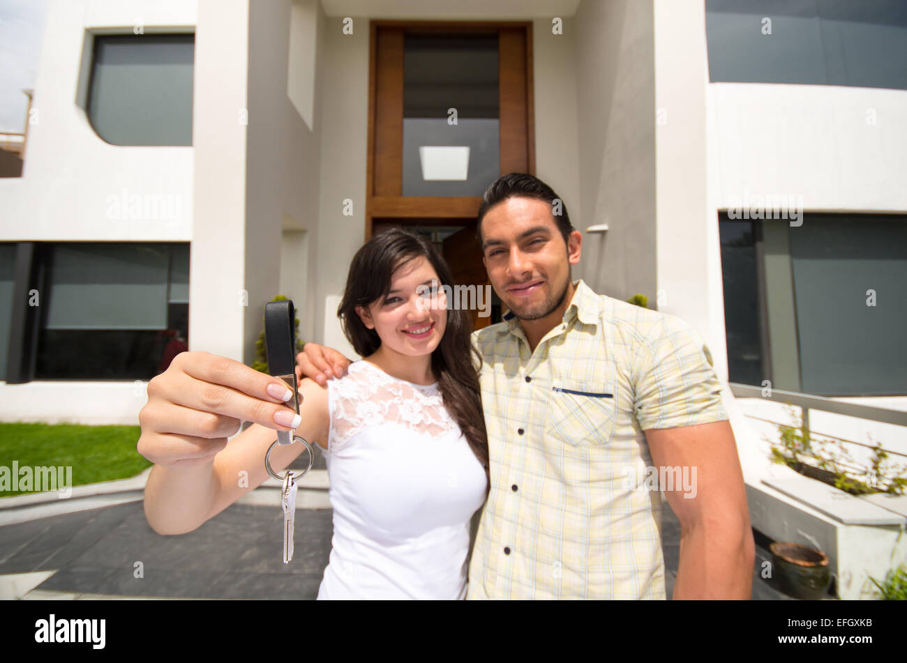 happy couple holding key to their new house Stock Photo - Alamy