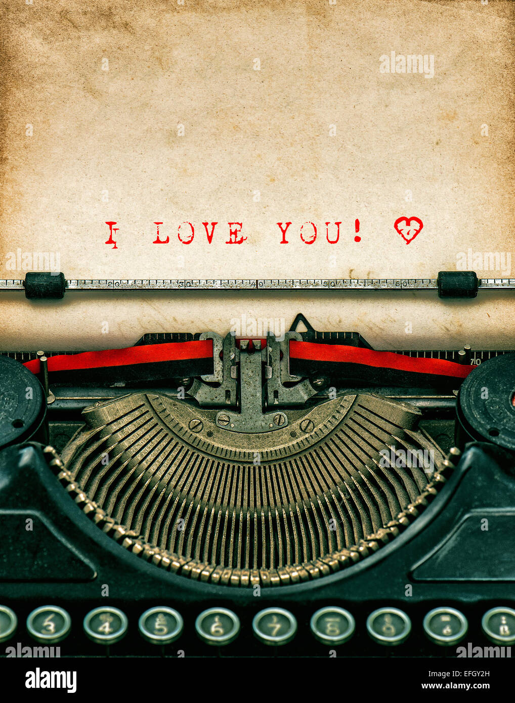Vintage typewriter with aged textured grungy paper. Sample text I love You! Valentines Day concept Stock Photo