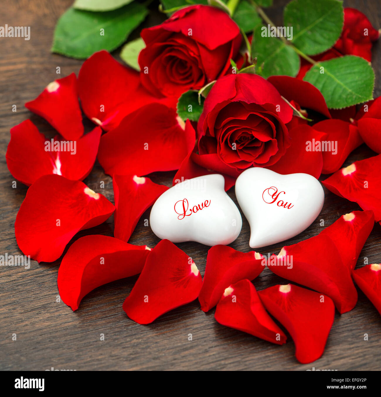 Red roses and two hearts. Valentines Day decoration. Holidays background.  Sample text Love You Stock Photo - Alamy