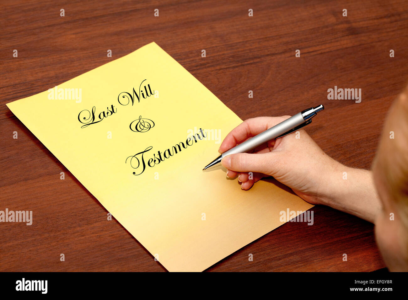 A young woman with a cover sheet for a 'Last Will & Testament' Stock Photo