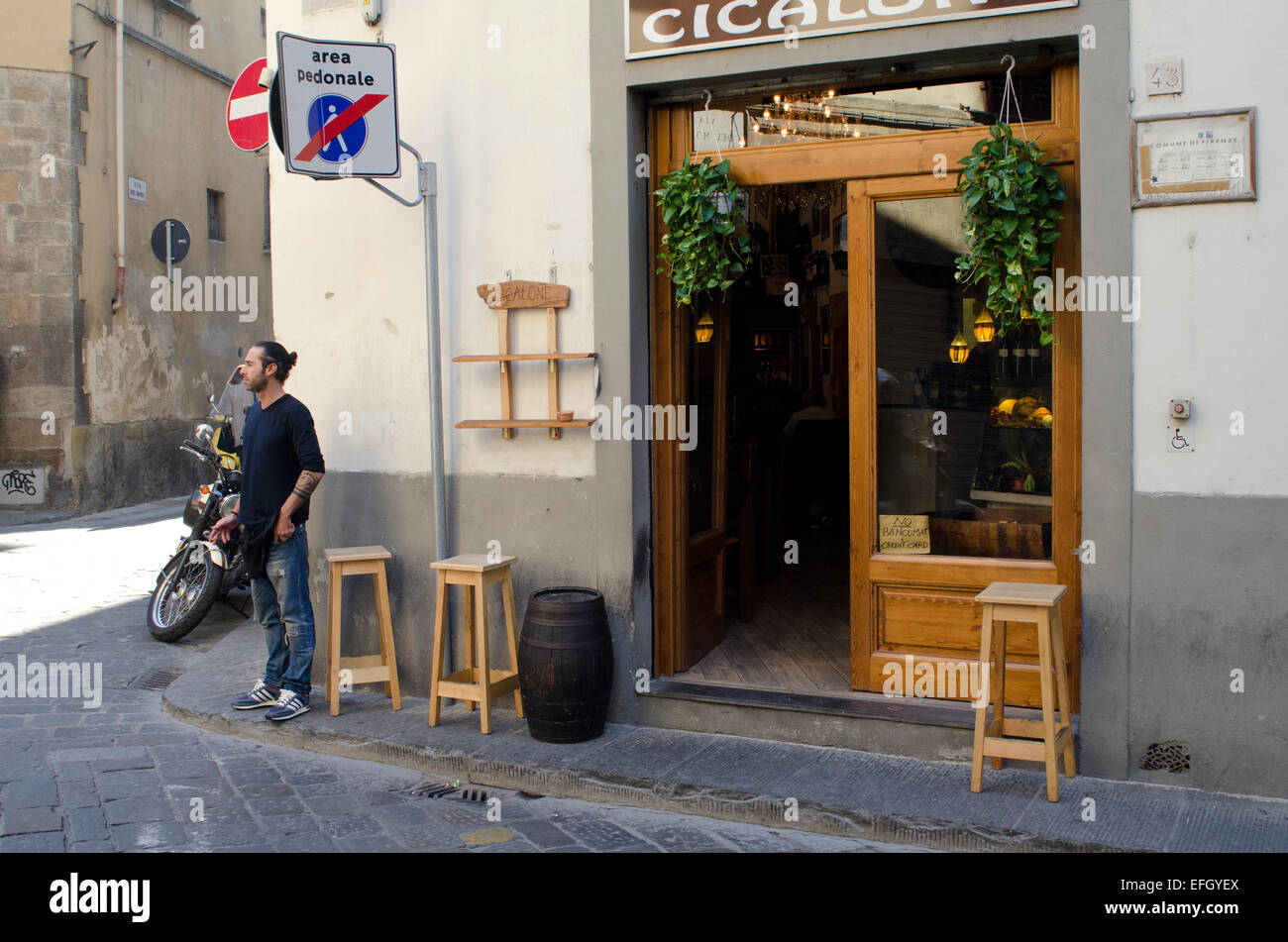 View of man outside bar in Florence, Italy Stock Photo