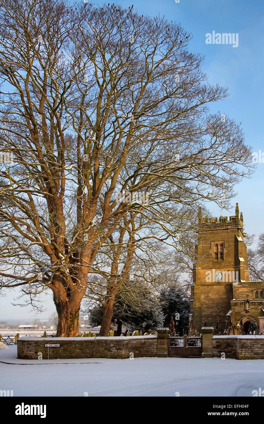 Winter snow and an English Parish Church in the small village of Slingsby in North Yorkshire in northern England. Stock Photo