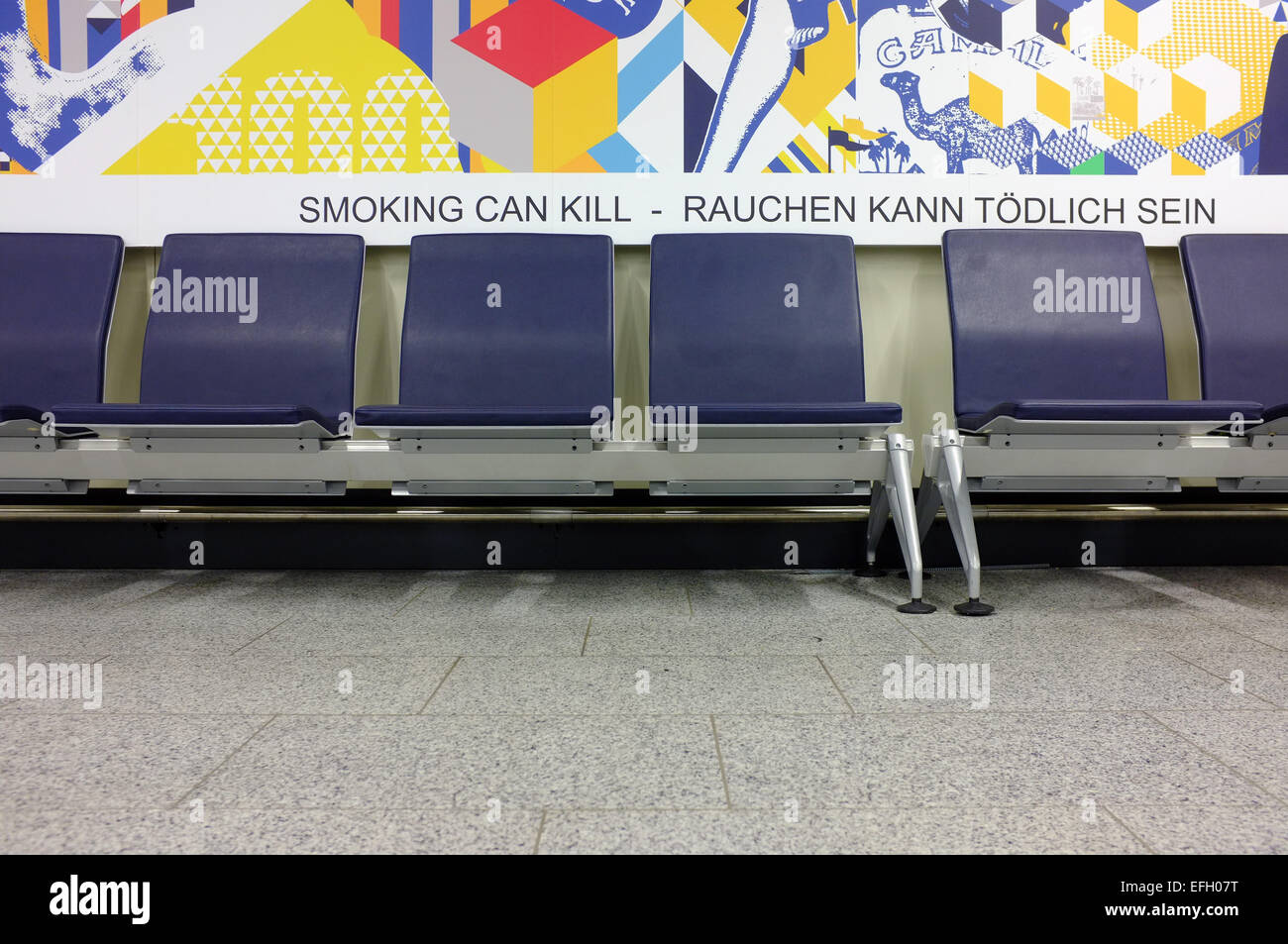 An anti smoking advert by a row of chairs in Frankfurt terminal. Stock Photo