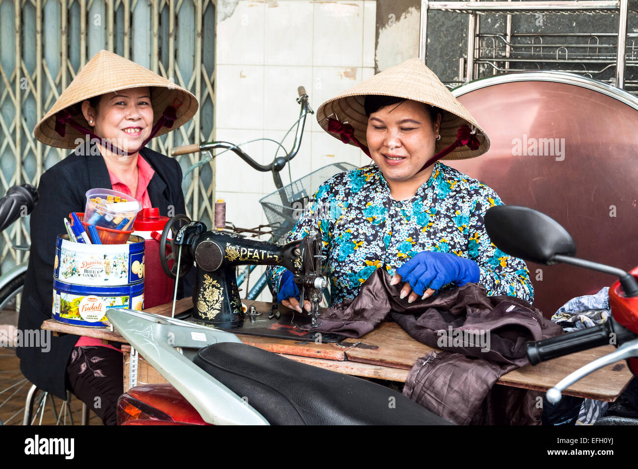Street tailor women altering clothes in Kon Tum, Vietnam Stock Photo
