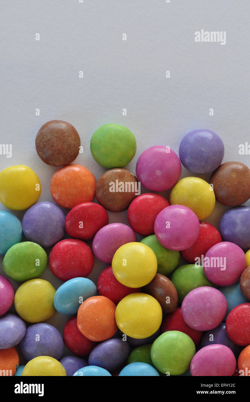 Colorful chocolate candy pieces on white background Stock Photo Alamy