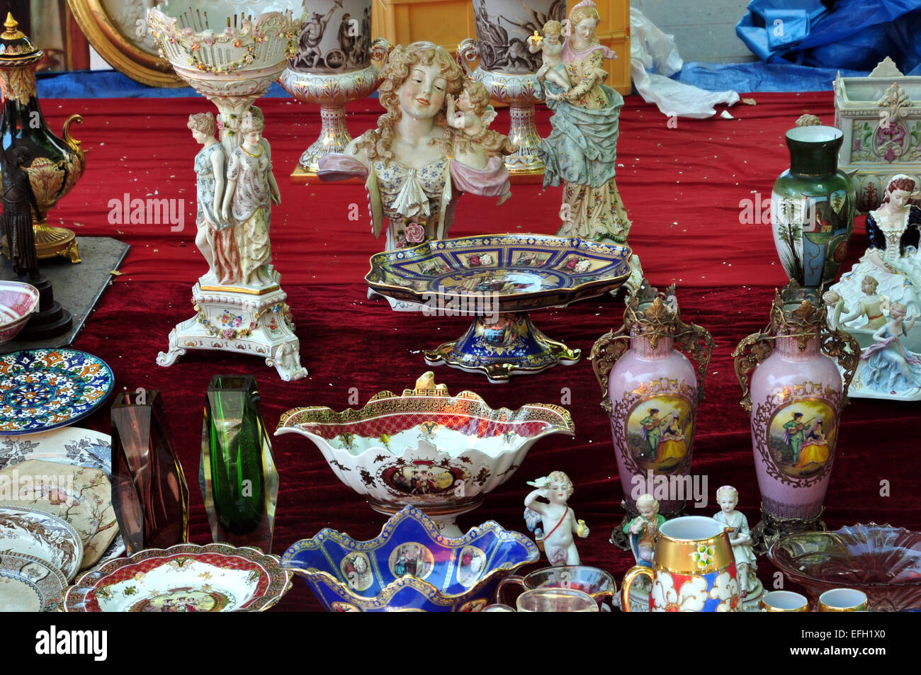 Porcelain vases statuettes and plates antique decorative objects background. Stock Photo