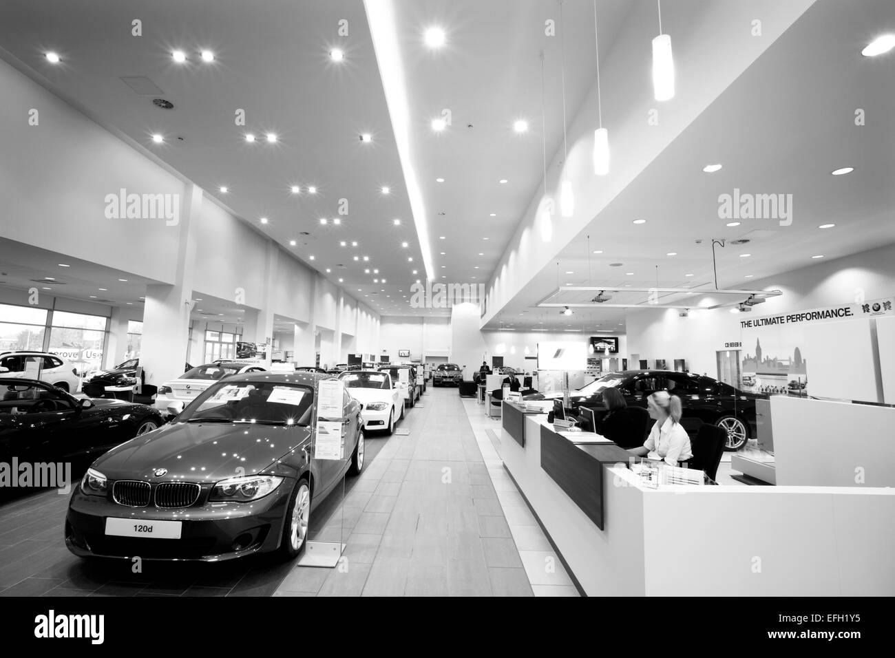 Interior shot of reception desk in car dealership, black and white