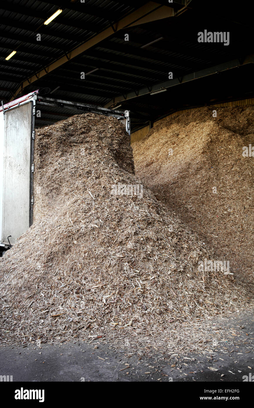 Lorry unloading forestry waste in loading bay at biomass plant Stock Photo