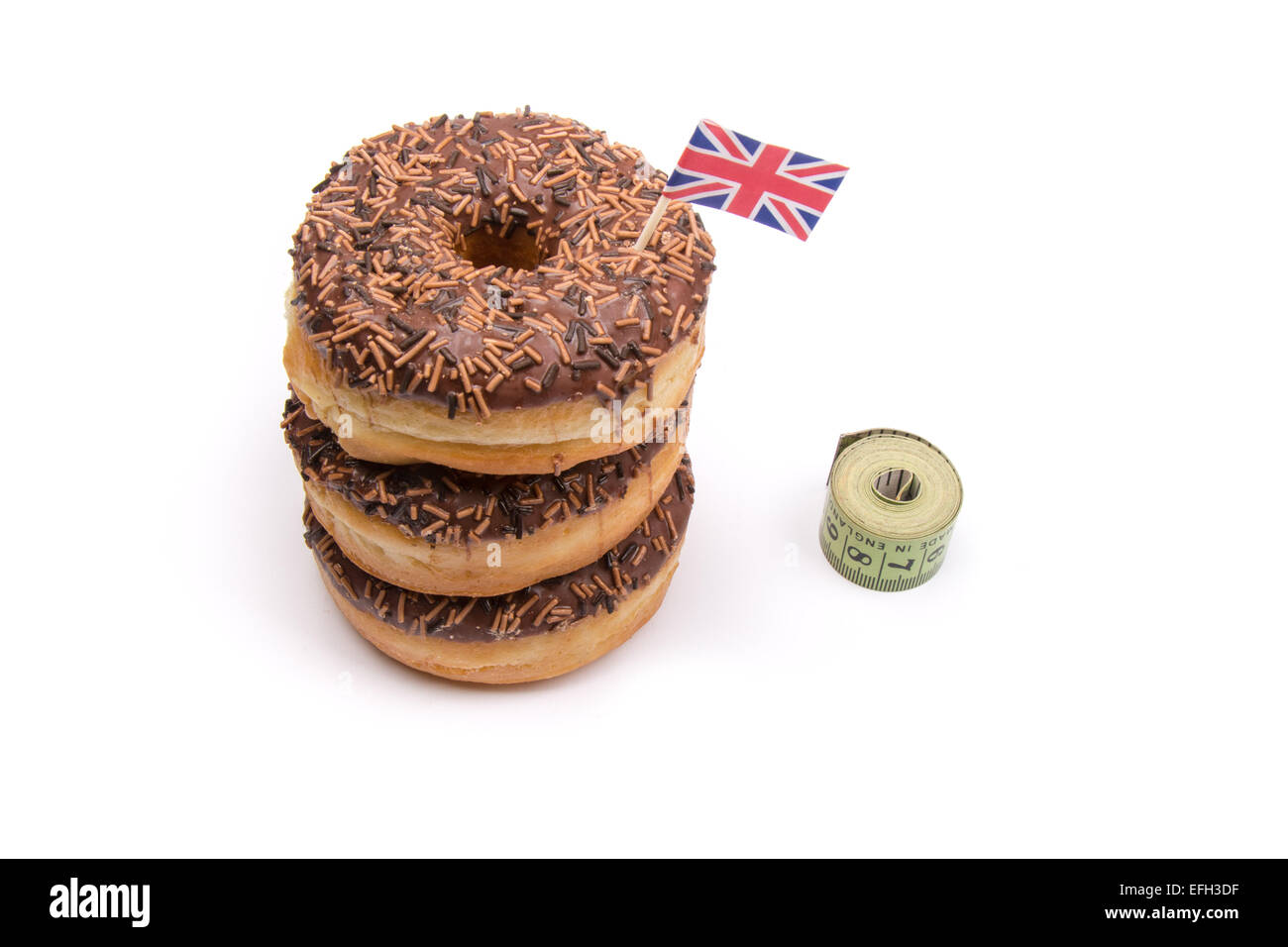 A pile of chocolate iced ring donuts on a white background with Stock