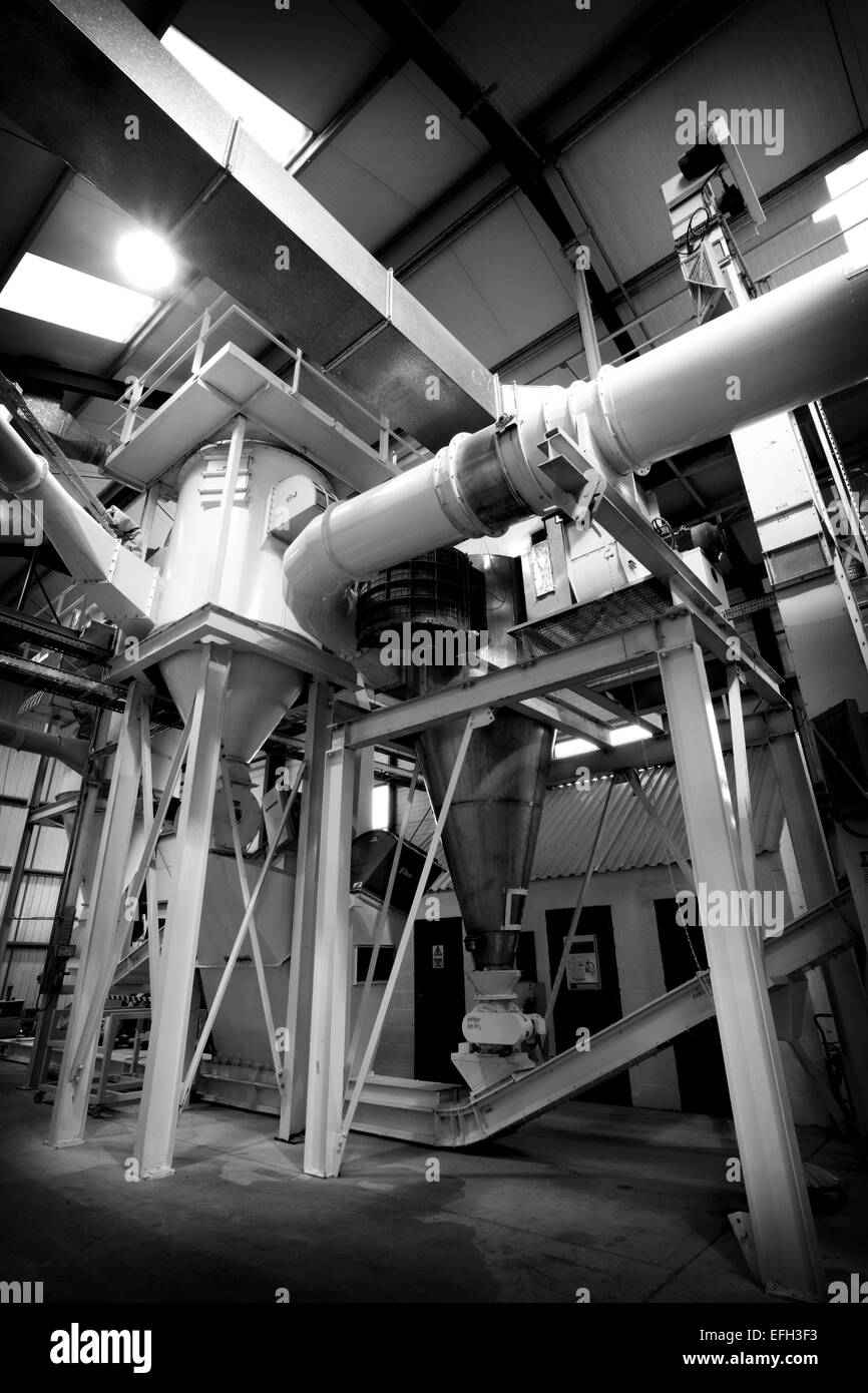 Industrial machinery and piping for production of biomass fuel, black & white Stock Photo